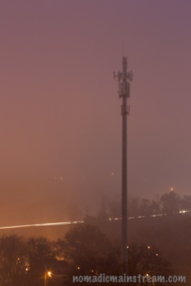 Cell tower, fog, and highway traffic